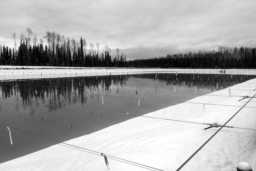 Lined produced water containment pond at a Western Canadian energy facility