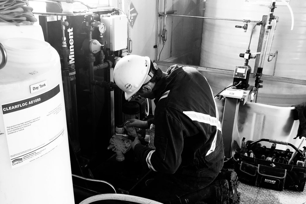 Fluid Intelligence technician servicing a chemical injection program in the field